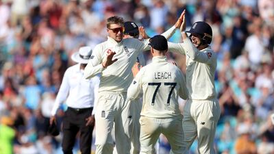England captain Joe Root, left, celebrates taking the wicket of Australia's Mitchell Marsh. PA