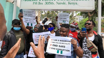Nigerians living in Kenya hold placards and shout slogans during a protest against the Nigerian Special Anti-Robbery Squad (SARS), outside the Nigeria High Commission offices in Nairobi, Kenya. EPA