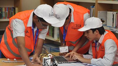 Attendees at a three-day workshop at Al Ittihad National Private School tackle an aeronautical problem. Courtesy Mubadala