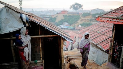 Rohingya refugee women go about their day at the Balukhali camp in Cox's Bazar, Bangladesh. Reuters
