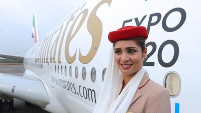 A flight attendant poses beside an Emirates Airbus A380 during a photo call at the India Aviation 2014 airshow in Hyderabad. Noah Seelam / AFP