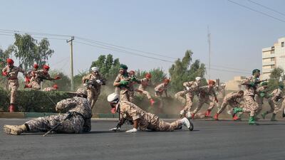 Iranian soldiers jump over a hedge as they run for cover during a terror attack that occurred during a military parade in the city of Ahvaz. EPA
