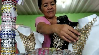 A worker arranges products composed of push-tabs from aluminium cans at the Philippine Christian Foundation in Manila. Noel Celis / AFP