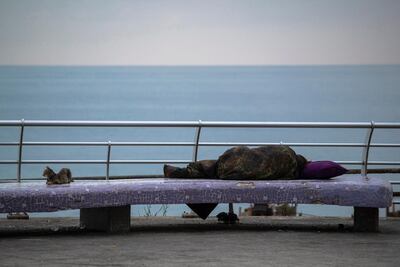 A homeless woman sleeps on the Mediterranean Sea Corniche in Beirut, Lebanon. The country needs urgent reforms to see a boost in its crippled economy. AP