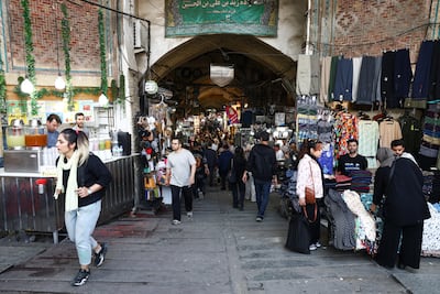 Shoppers at a Tehran bazaar. Iran's economy is forecast to shrink by 6.1 per cent this year. Reuters