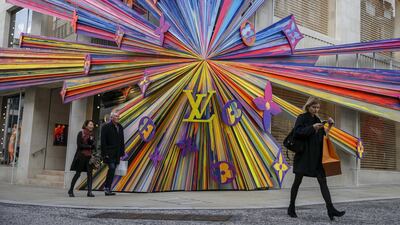 Shoppers pass colorful store-front design on the front of a Louis Vuitton store. A 2018 survey found that 53% of millennials expect to become millionaires at some stage in their lives. Bloomberg