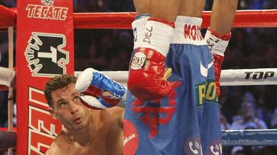 Manny Pacquiao stands over Chris Algieri during his win over the American challenger last November in Macau, China. Mike Young for The National / November 23, 2014