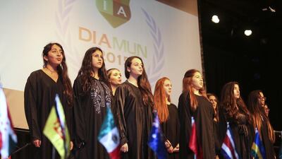 Students sing the UAE national anthem at American University in Dubai. Sarah Dea / The National