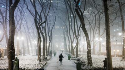 People walk through Manhattan in the snow storm in New York City. AFP