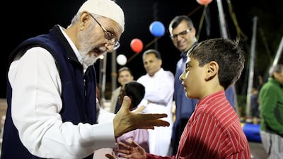 Muhammad Ali, centre, looks on while his father Naseem Ahmed talks to grandson Murtaza Ali, 9, at the Muslim Community Association in Santa Clara.