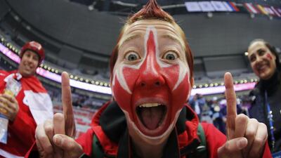 A Canada fan with his face painted with a maple leaf symbol gestures before the men’s ice hockey gold medal game between Sweden and Canada at the Sochi 2014 Winter Olympic Games February 23, 2014. Mark Blinch / Reuters