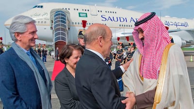 Saudi Arabia's Crown Prince Prince Mohammed bin Salman is welcomed by French Foreign Minister Jean-Yves Le Drian and the French ambassador to Saudi Arabia Francois Gouyette, left, at Le Bourget airport, north of Paris, on April 8, 2018. Ahmed Nureldine / AFP