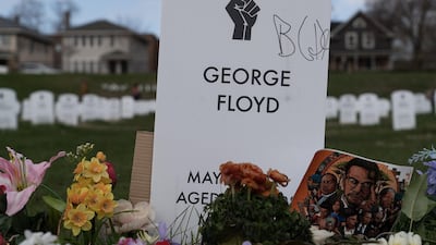 A makeshift tombstone for George Floyd near the spot where he was murdered by former police officer Derek Chauvin. Willy Lowry / The National