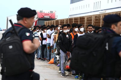 Migrants wait to board a boat on the Italian island of Lampedusa on June 8. AFP