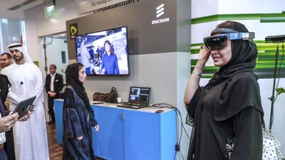 A visitor tries out the 5G VR headset at the Hologram Communication stand.