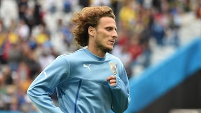 Diego Forlan warms up before Uruguay's 2014 World Cup Group D match with England on Thursday. Luis Acosta / AFP / June 19, 2014