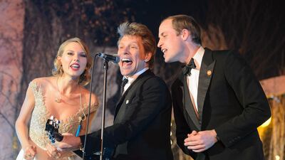 Prince William, right, sings with US singers Jon Bon Jovi, centre, and Taylor Swift during the Centrepoint gala dinner at Kensington Palace in London, on November 26, 2013. AFP