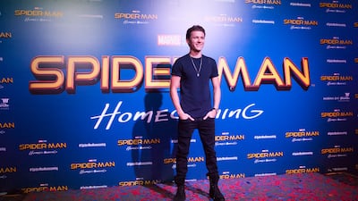 Tom Holland, in black jeans and a blue shirt, poses during a 'Spider-Man: Homecoming' event in Singapore on June 6, 2017. Getty Images