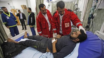 Palestinian medics at a hospital in Rafah tend to a man who they said was wounded in an Israeli airstrike. Ibraheem Abu Mustafa / Reuters / March 13, 2014