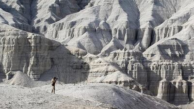 A tourist takes pictures at the Aktau mountain range in Altyn-Emel national park. Shamil Zhumatov / Reuters