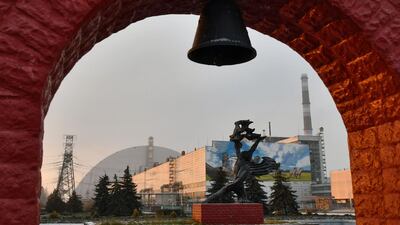 A monument in front of the giant protective dome built over the sarcophagus of the destroyed fourth reactor of Chernobyl nuclear power plant. AFP