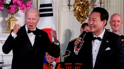 US President Joe Biden enjoys South Korean President Yoon Suk-yeol's singing at an official state dinner at the White House in Washington. Reuters