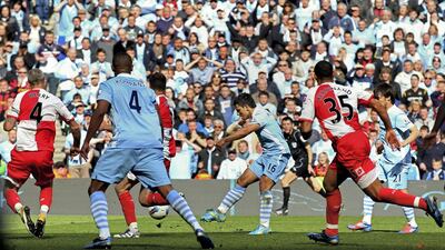 Sergio Aguero scores with virtually the last kick of the game against QPR hand Manchester City their first Premier League title on May 13, 2012. Getty Images