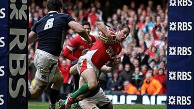 Shane Williams squeezes through the Scotland defence to score the game-winning try in the dying moments of yesterday's game.