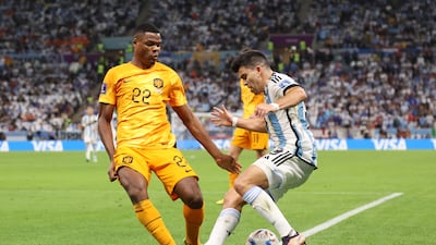 Dutch defender Denzel Dumfries fouls Marcos Acuna of Argentina in the box which leads to an Argentina penalty. Getty