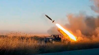 An image released by Hayat Tahrir Al Sham, the former Al Qaeda affiliate that controls Syria's Idlib region, shows its fighters firing a missile at government forces. Ibaa News Agency via AP