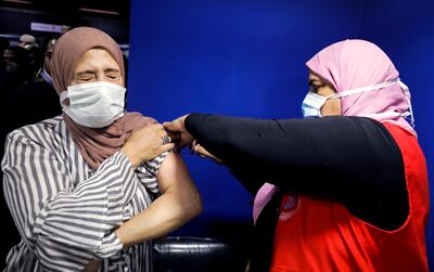 A woman receives a dose of Covid-19 vaccine at a vaccination centre at the Sadat metro station in Cairo. Reuters
