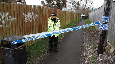 A police officer stands behind cordon tape in an alleyway near the home of former Russian intelligence officer Sergei Skripal in Salisbury, UK / Reuters