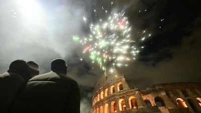 Fireworks expode over the Colosseum in central Rome during New Year celebrations. AFP