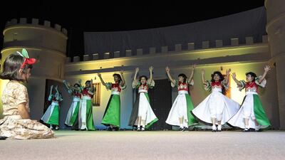 Children perform a traditional dance to celebrate in Sharjah National Park. Jeffrey E Biteng / The National