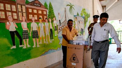 Police and electoral officials carry ballot papers and boxes from a distribution centre in Hambantota in southern Sri Lanka. AFP