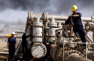 In this 2009 file photo, Iraqi labourers work at the Rumaila oil refinery in Zubair near the city of Basra. AP Photo