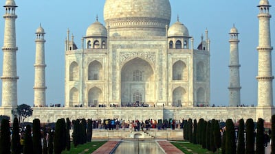Tourists stand in front of the historic Taj Mahal in the northern Indian city of Agra. Vijay Mathur/Reuters