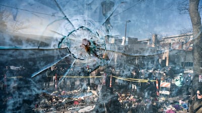 A gunshot hole in a window near a memorial for nurse Alex Pretti, 37, who was shot dead by US federal immigration (ICE) agents in Minneapolis, Minnesota, on January 24. AFP