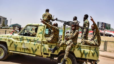 Sudanese soldiers flash the victory gesture. AFP