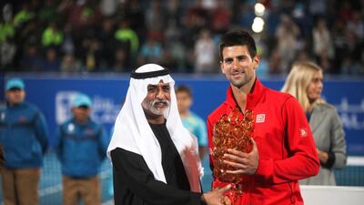 Novak Djokovic collects the trophy from Sheikh Nahyan bin Mubarak, Minister of Culture, Youth and Community Development in 2013. Lee Hoagland / The National