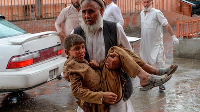 A volunteer carries an injured youth to hospital, following a bomb blast in Haska Mina district of Nangarhar Province. AFP
