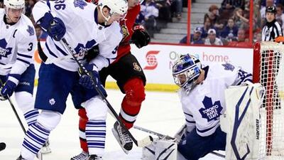Toronto goalie James Reimer stops a shot by ottawa Senators' Mike Zibanejad.
