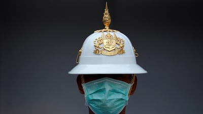 A Thai Royal Guard wears a mask while he stands inside the Royal Palace in Bangkok. Reuters