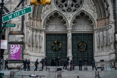 Police officers detain a man who opened fire outside the Cathedral Church of St John the Divine in Manhattan on Sunday. Last year, this was a venue for Christmas concerts and other festivities. Reuters