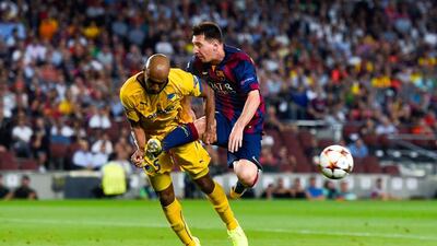 Apoel's Carlao, left, challenges Barcelona's Lionel Messi during their Uefa Champions League match at Camp Nou. Barcelona won 1-0. David Ramos / Getty Images
