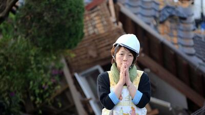 A residents stand in front of damaged house in Mashiki, Kumamoto prefecture, southern Japan. A powerful earthquake struck southern Japan early Saturday, barely 24 hours after a smaller quake hit the same region. Naoya Osato / Kyodo News via AP