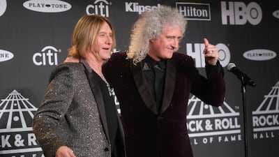 Joe Elliott, of Def Leppard, left, and Brian May, of Queen, pose together. AP