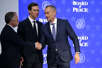 Nickolay Mladenov, right, shakes hands with US special envoy Steve Witkoff at the World Economic Forum in Davos, where the Board of Peace was launched, in January. AFP