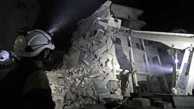 Members of the Syrian Civil Defence (White Helmets) search for victims as a building collapsed days after a reported air strike on the town of Ariha, in the south of Syria's Idlib province. AFP