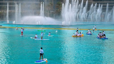 People paddle boarding in the Burj Khalifa fountain. Karim Sahib / AFP